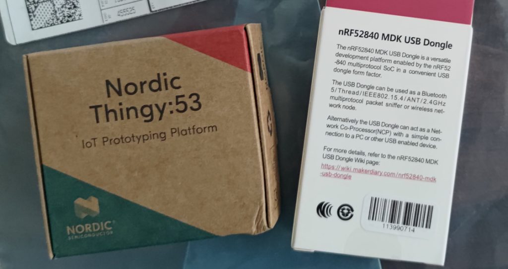 Thread hardware, showing packaging boxes for the Nordic Thingy:53 and nRF52840 MDK USB Dongle